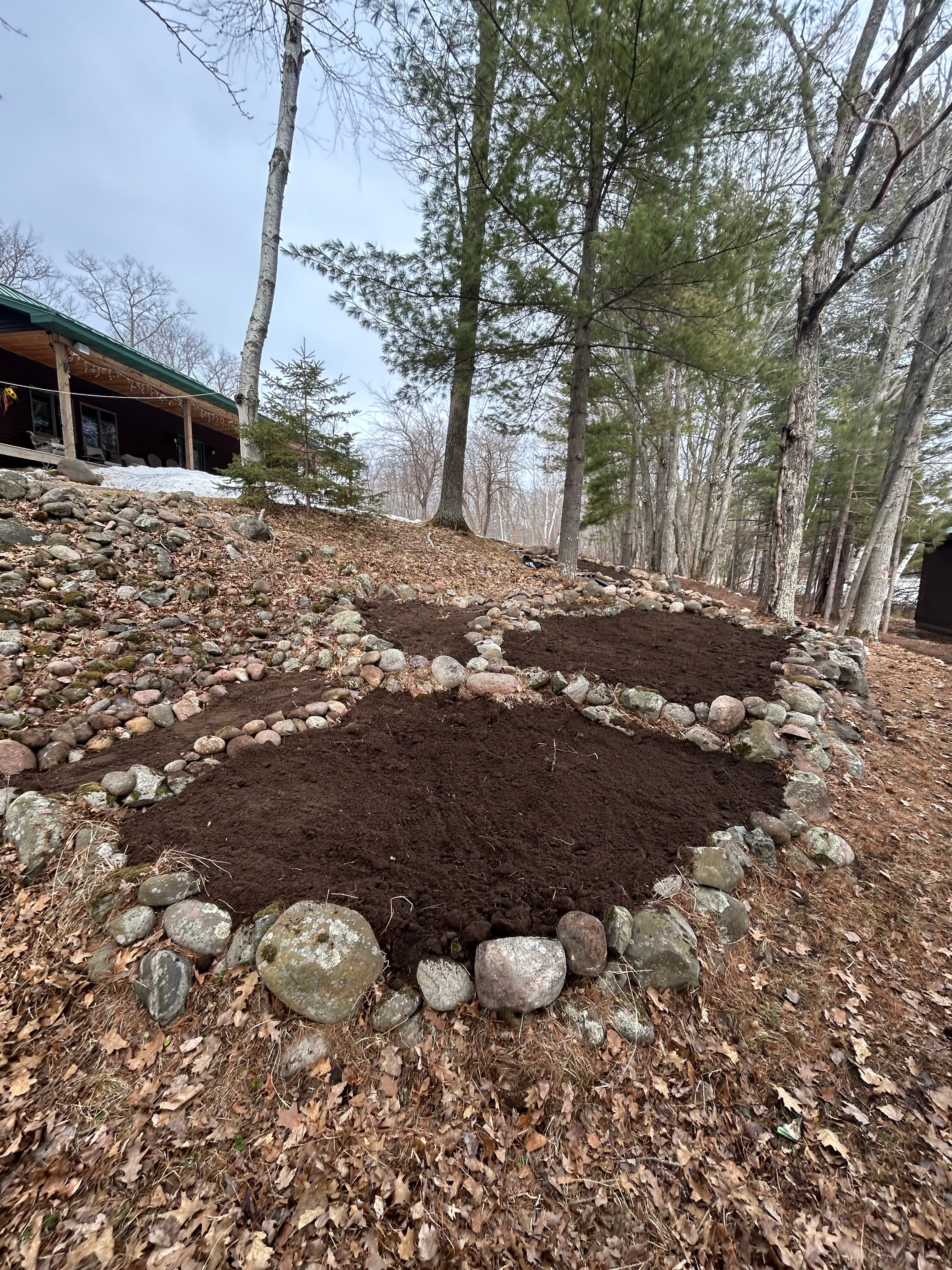 Project Garden Bed Construction and Stone Edging at a Wooded Cabin Property image