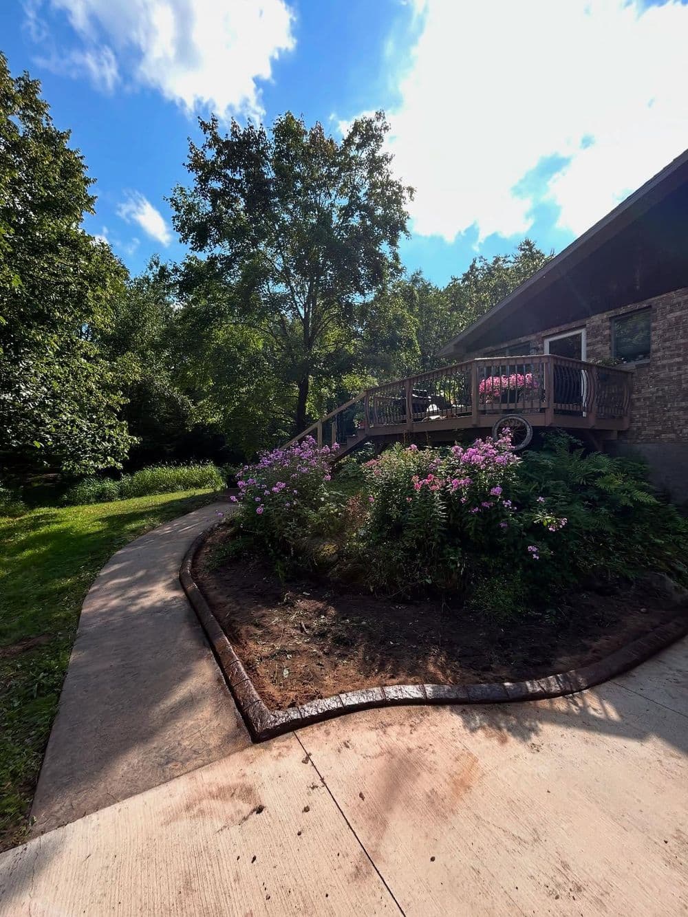 Project Natural Stone Curb Install Cleans Up Overgrown Garden Beds image
